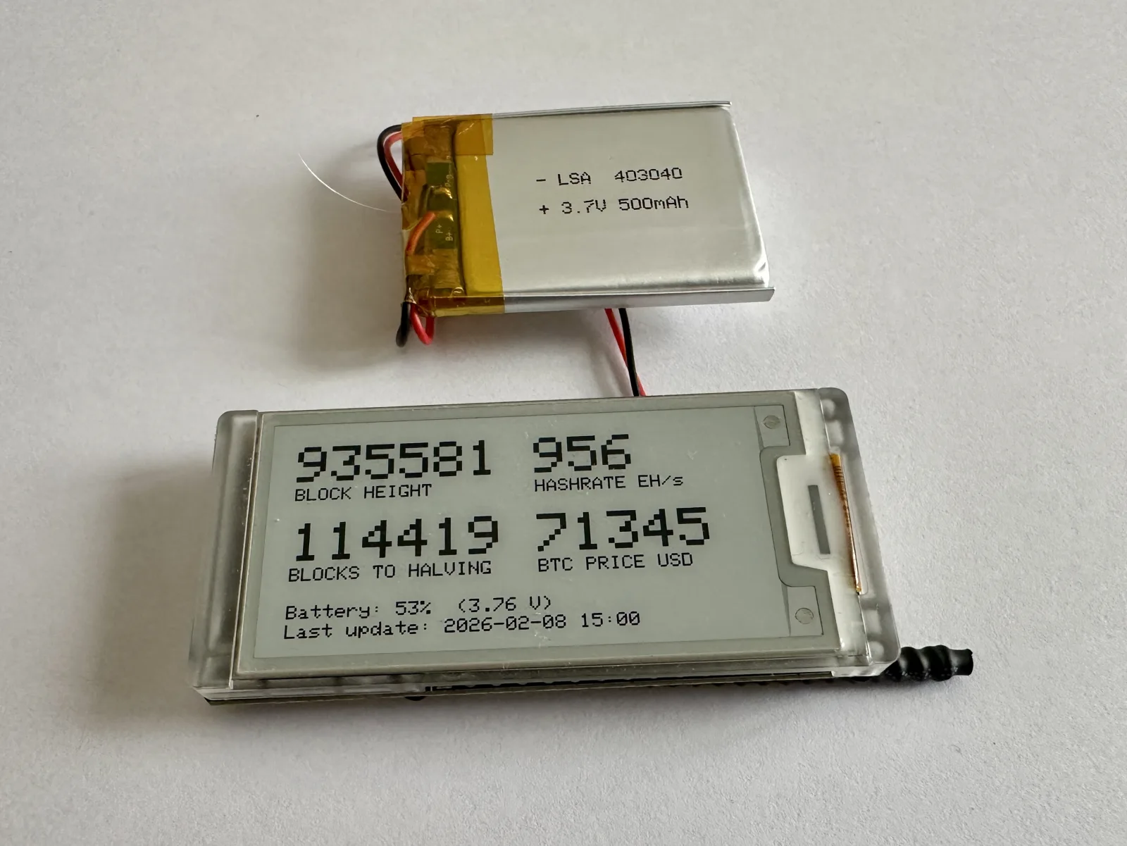 Front view of the Heltec Vision Master E213 running the DIY block clock firmware